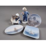 A Bing and Grondahl figure group of two children reading, another similar of a young boy, 6" high, a