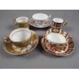 A Davenport Imari decorated cabinet cup and saucer, an early 19th century trio and a Kakiemon