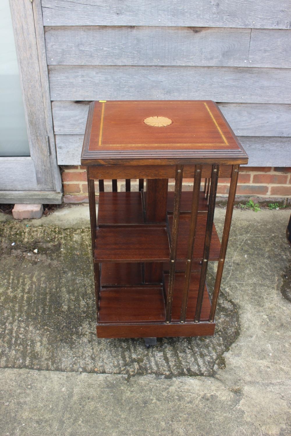 A mahogany and satinwood banded revolving bookcase, 18" square x 32" high