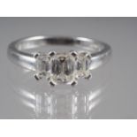 A platinum and diamond three-stone dress ring, size 'O' 5.8g gross (central stone 0.5ct approx)