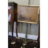A 19th century brass pole screen, on triform base with aquatint panel, 50" high