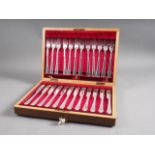 A set of twelve silver plated fish knives and forks, in mahogany canteen