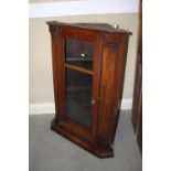 An oak corner cabinet with dentil moulding enclosed glazed panel door, 25 1/2" wide x 15 1/2" deep x
