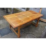 An Oriental hardwood and marble inset refectory style table, on column turned and stretchered
