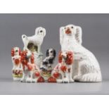 A 19th century Staffordshire watch group with poodle and spaniels, 9" high, a Staffordshire spaniel,