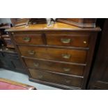 A Victorian walnut chest of two short and three graduated drawers with pierced brass handles, on