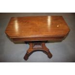 A William IV mahogany fold-over top tea table, on shaped column and quadruple splay support, 34"