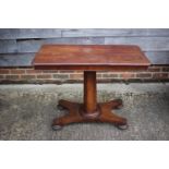 A late 19th century walnut adjustable reading table, on faceted column and quatreform base