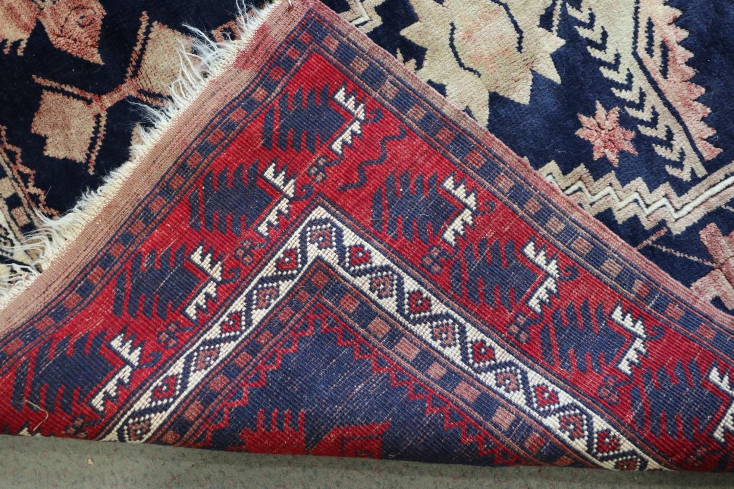 A Caucasian tribal rug with stylised floral centre on a blue ground and multi-bordered in shades - Image 3 of 3