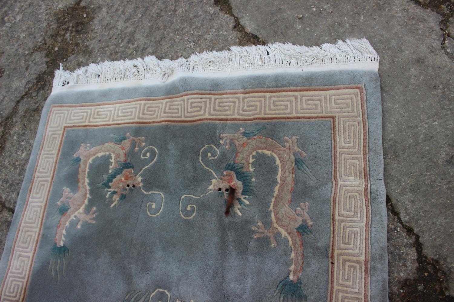 A Chinese contour pile rug with dragon design on a grey ground, 75" x 49" - Image 2 of 3