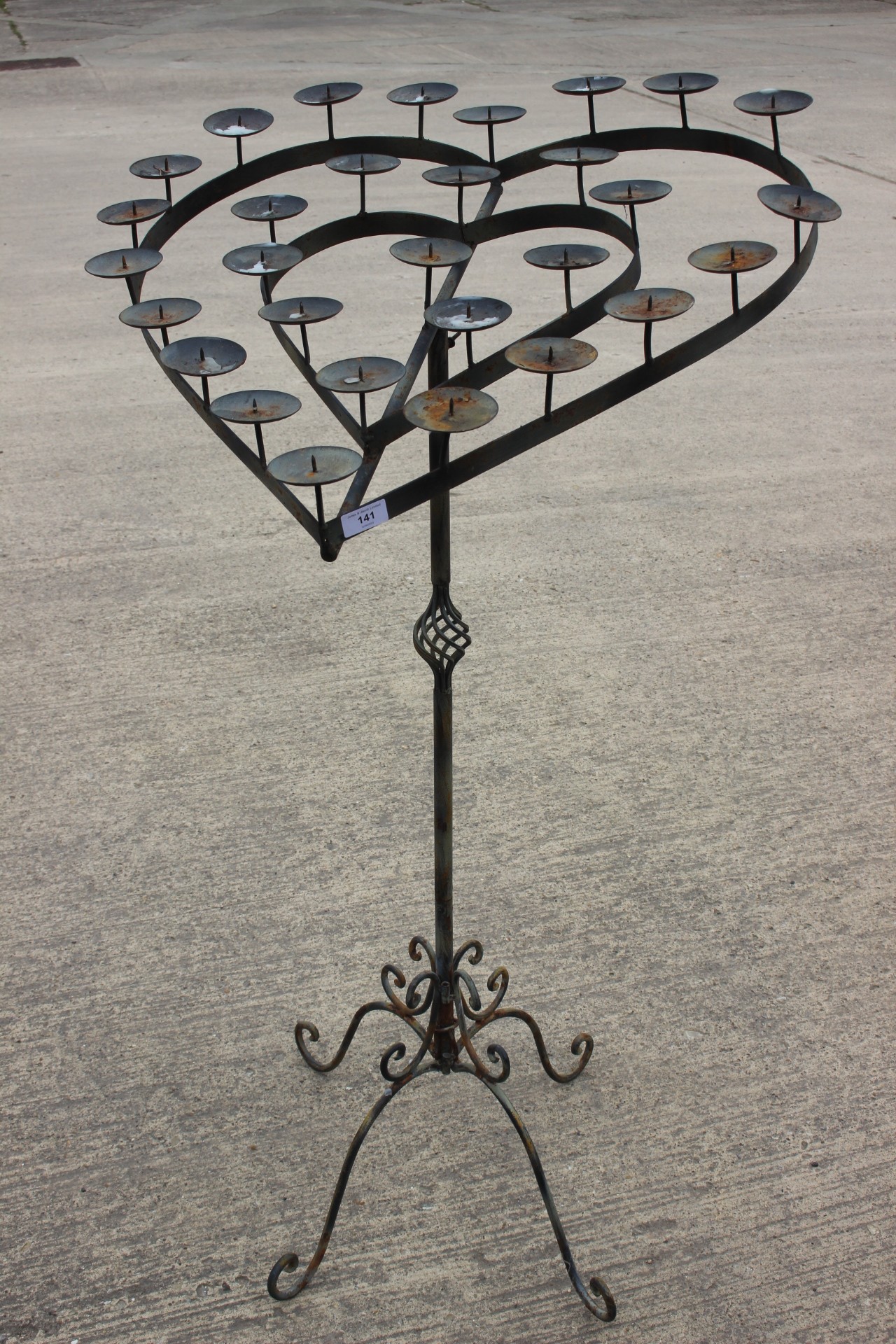 A wrought iron heartshaped candle stand