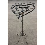 A wrought iron heart-shaped candle stand