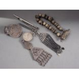 A vintage Bedouin white metal triangular pendant, a Maria Theresa thaler pendant, and other