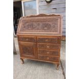 A Kashmir carved walnut fall front bureau with all-over scroll design, fitted writing compartment