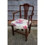 A 19th century mahogany and inlaid elbow chair with serpentine seat panel, on moulded and