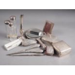 A silver backed dressing table mirror, two silver cigarette boxes, three dressing table jars, a