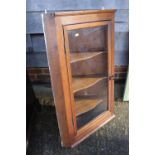 An oak corner hanging cabinet, interior fitted shape shelves enclosed glazed panel door, 23" wide