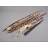 A Botswana Saan hardwood short bow and quiver with arrows, and three pieces of African tourist art
