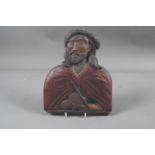 A carved softwood and polychrome part bust of a saint/penitent with rope around his neck and