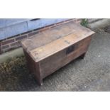 An early 18th century oak boarded coffer, on panel end supports, 35" wide x 16" deep x 19 3/4" high