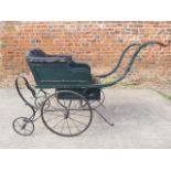 A late 19th century postman's handcart pram with original green paint and sliding box seat
