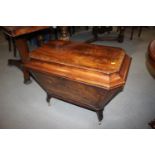 A 19th century figured mahogany sarcophagus wine cooler fitted unit, on square castored supports