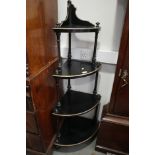 A late Victorian ebonised and gilt four-tier corner whatnot, on castored supports, 28" wide x 16"