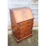 A modern figured mahogany fall front bureau, fitted four drawers, on bracket feet, 21" wide x 17"
