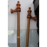 Two polished as mahogany curtain poles and rings, each 86" long approx