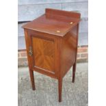 A Maples Edwardian mahogany and box inlaid ledge back bedside cupboard enclosed one door, on