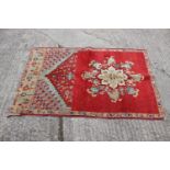 A Middle Eastern wool prayer rug with medallion, geometric and floral designs in shades of blue