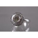 A white metal and diamond cluster ring, central stone 0.7ct approx, size K, 5.8g