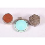 A light green guilloche enamel compact, a hexagonal silver pill box with engraved decoration and a