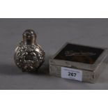 An embossed silver scent bottle case and a silver and tortoiseshell cigarette box