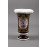 An early 19th century flared rim vase with panelled floral decoration and gilt highlights, 9 1/2"