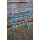 A blue painted towel rail and a pair of beech stools with elm panel seats