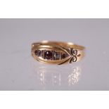 A 15ct gold gypsy ring set three rubies and two diamonds, 1.7g gross