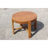 A 1950s Utility oak circular top low coffee table, on stretchered supports, 22" dia x 16" high