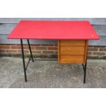 A 1970s desk with leatherette top, fitted three drawers, on metal supports, 39" wide x 24" deep x