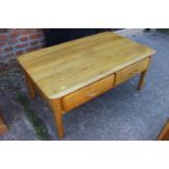 A light oak low coffee table, fitted four shallow drawers, 39" wide x 23" deep x 17" high