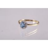 An 18ct gold, diamond and aquamarine cluster ring, size O/P, 2.2g