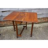 A figured mahogany Sutherland drop leaf table, on square supports and claw and ball feet, 25 1/2"