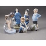 Five Royal Copenhagen figures, girl bathing (1229), boy with a bucket (3519), boy with a ball (