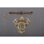 An Edwardian yellow metal peridot and seed pearl set pendant brooch, 6.6g, and a similar brooch, 2.