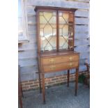 A late Georgian mahogany secretaire bookcase, the upper section enclosed lattice glazed door over