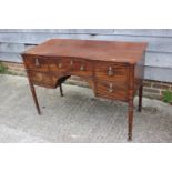 A George III mahogany inverse breakfront sideboard/dressing table, fitted five drawers with brass
