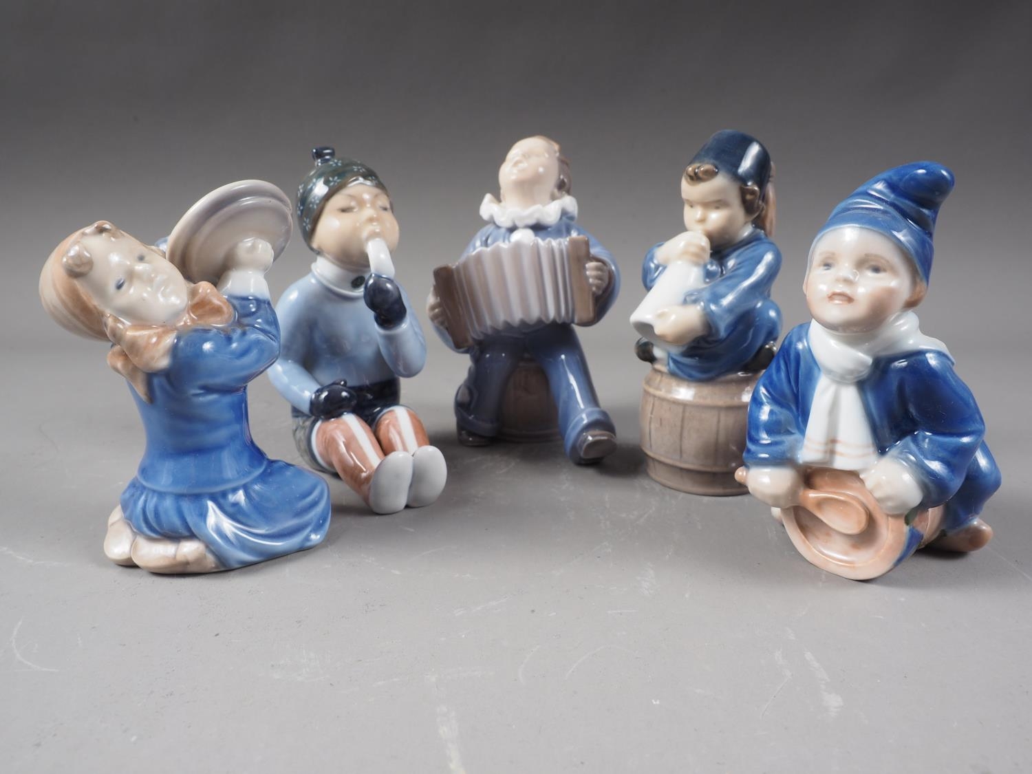 A Royal Copenhagen four piece child band (3677, 3689, 3667 and 148) and one other child, "