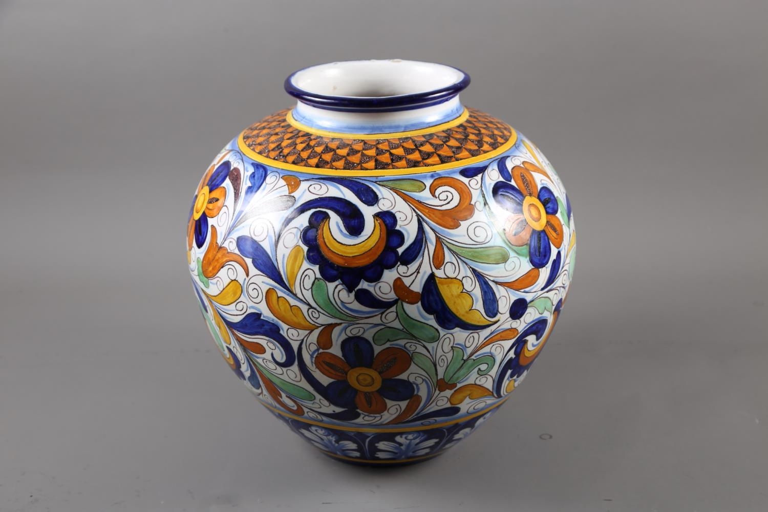 A Cantagalli bulbous vase with floral and scrolled decoration, 13" high