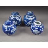 Three Chinese blue and white ginger jars and covers with prunus decoration and double ring marks