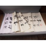 Approximately twenty Chinese calligraphy scrolls, unframed